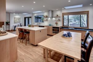 Nip Tuck Midcentury beautiful transformation of small dark subdivided spaces into large open kitchen for entertaining.