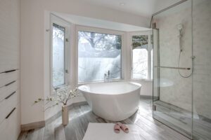 This large and unique soaking tub is enjoying it's new home located in this simple, sleek, modern, and bright primary bathroom suite in Bellevue, WA.