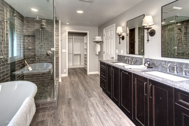 This traditional primary bathroom is part of a full bedroom suite. It combines masculine and feminine elements to best suit both homeowners' tastes.